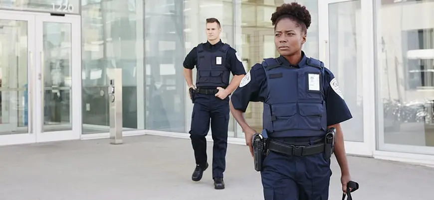 Professional security guards patrolling outside a commercial building in Seattle CBD